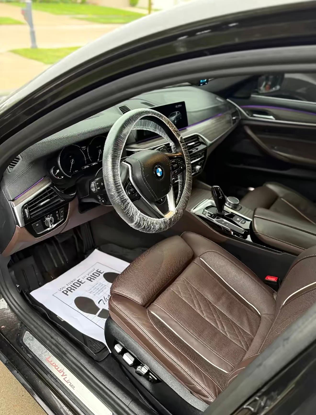 A freshly detailed BMW interior — conditioned brown leather and spotless trim — completed at a client's home