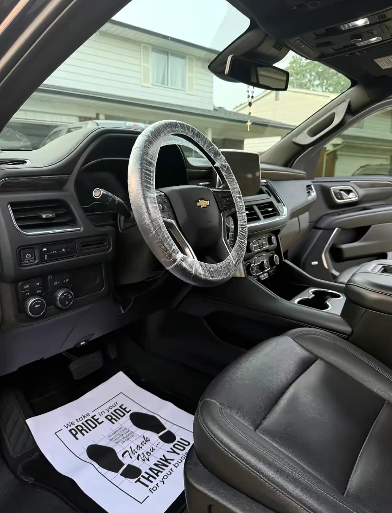 A freshly detailed SUV cabin — clean black leather, spotless dash and center console